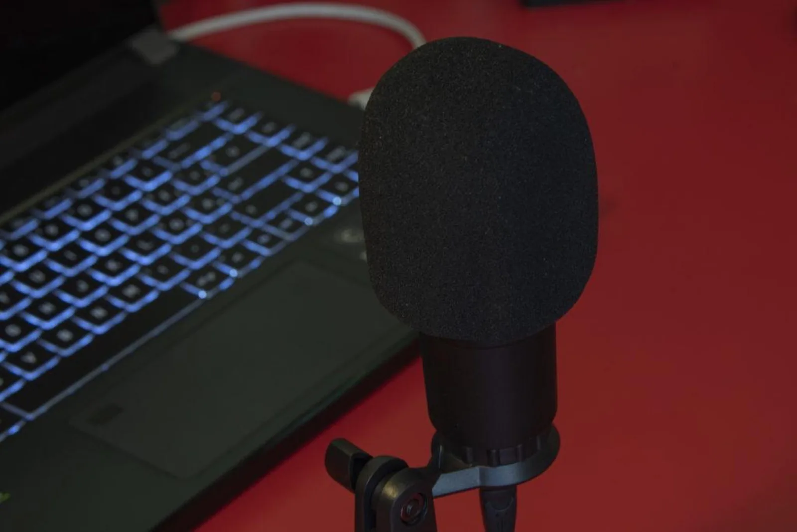 Push-to-talk over cellular desk microphone plugged into a laptop on a control room desk